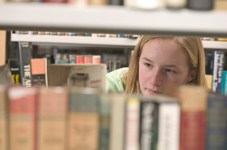 Girl Browsing Books at the Library